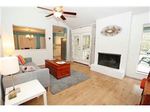 Cozy Living Room With Floor To Ceiling Brick Fireplace