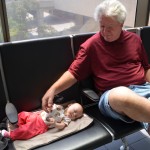 Happier moments from Isla's travels: baggage claim with Grandpa